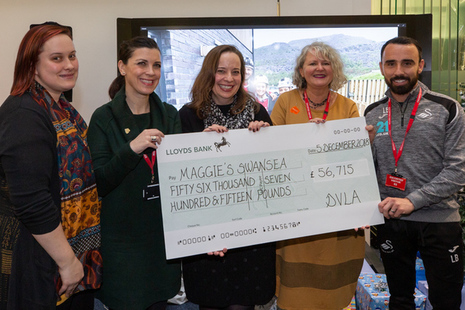 Representatives from Maggie's Swansea, including Leon Britton of Swansea City Football Club, accept the cheque for £56,715 from DVLA's Chief Executive Julie Lennard