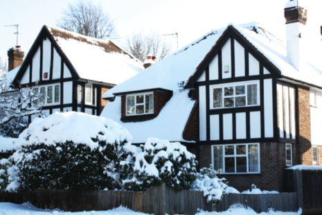Detached mock Tudor house in snow