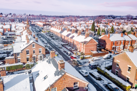 Aerial view of suburban streets in the snow.