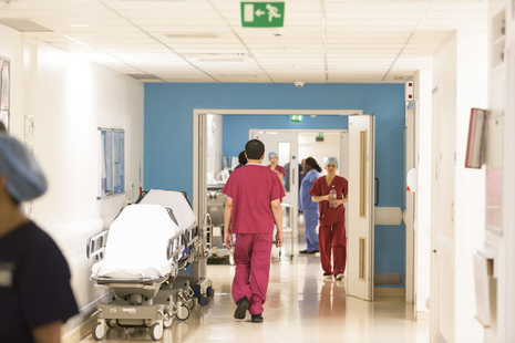 Nurses walking through a hospital corridor.