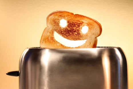 Toast with smiley face popping out of toaster