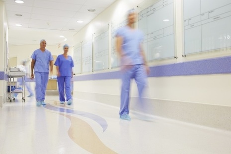 Doctors walking along hospital corridor