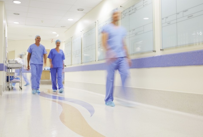 Doctors walking along hospital corridor
