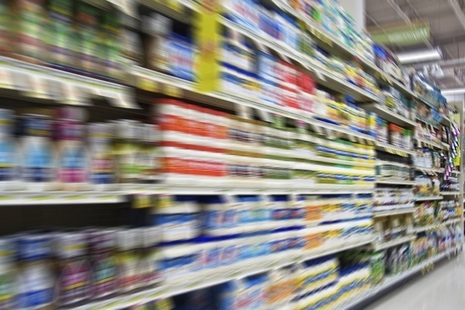 Blurry image of supermarket shelves.