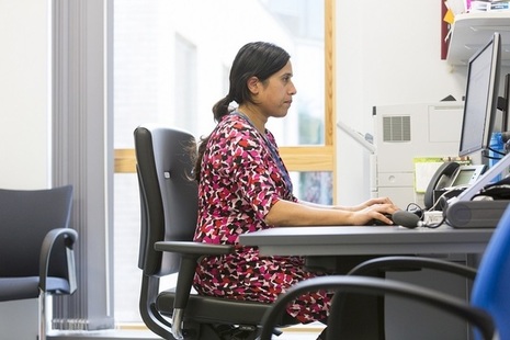 A doctor works at her desk.