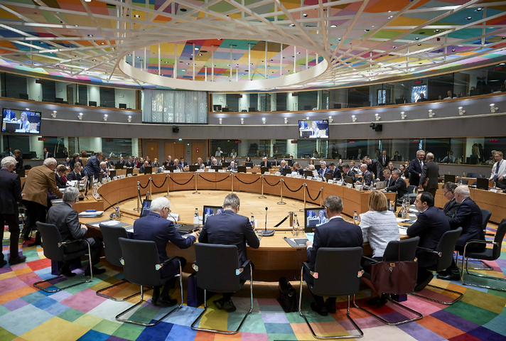 People sat round a table in the EU