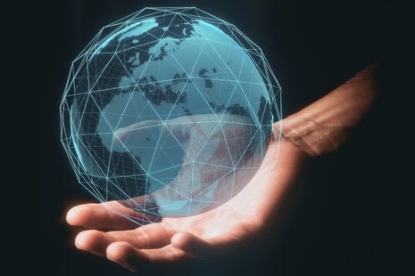 Hand holding globe