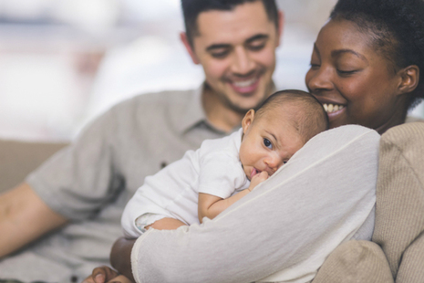 Parents with a young baby (credit: FatCamera/iStock - ID 901666764)