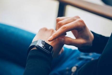 Close up of a smart watch user on her device