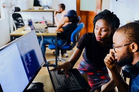 Man and woman looking at a computer