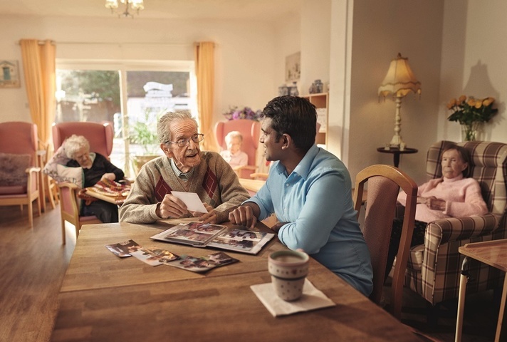 Carer talking to a gentleman in a care home