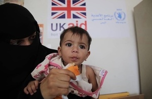 A woman feeds a malnourished child with therapeutic food funded by UK aid in Yemen. Picture: WFP