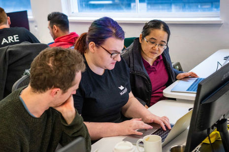 Three people working on laptops