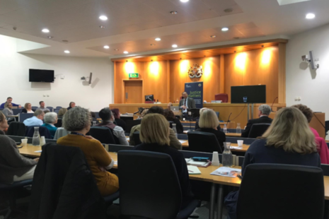 Image of audience listening to a speaker