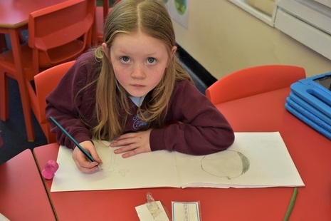 Female pupil writing at desk