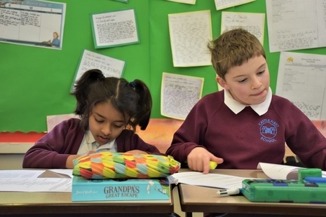 Male and female KS2 pupils writing