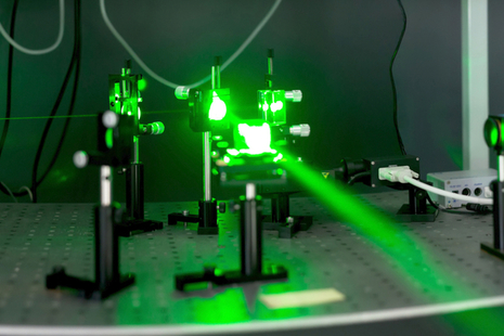 A image of a green laser beam and emitter.