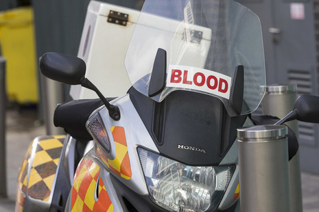 A parked motorbike for transporting donated blood.