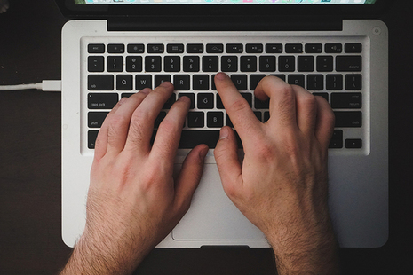 Person typing on laptop