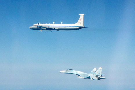 Two Russian aircraft fly in the sky after being intercepted by RAF Typhoons