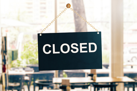 Closed sign on a glass office door.