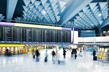 People walking across an airport depature lounge