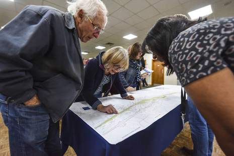 Members of the public studying a map at an engagement event