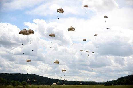 Paratroopers fly through the sky
