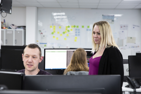 Companies House colleagues at work in front of a computer screen.