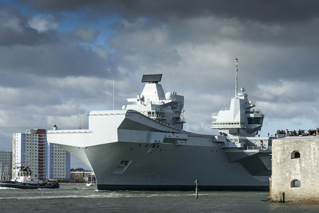 HMS Queen Elizabeth accompanied by her support craft, sailing from her home in Portsmouth