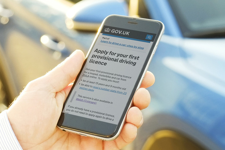 Image of person using smart phone to apply for a driving licence