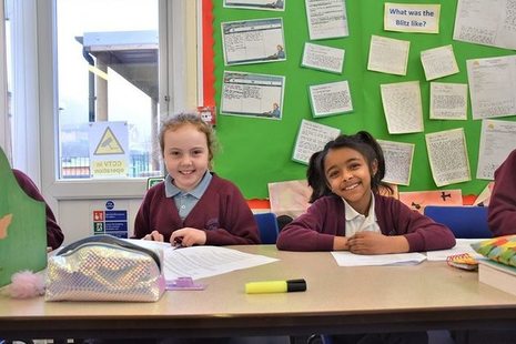 Two female pupils smiling