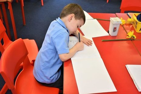 Male pupil writing