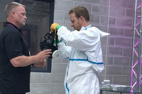 Volunteer is dressed in air fed suit