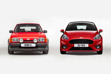 Image of one red 1989 car and one red 2019 car