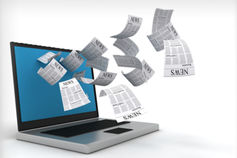 Personal Computer (PC) with newsletters on the screen.