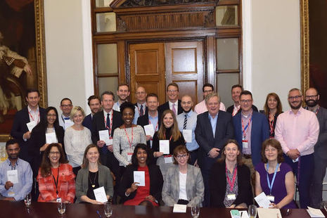 A group of people holding copies of the art of brilliance