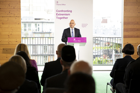 The Home Secretary delivering a speech.
