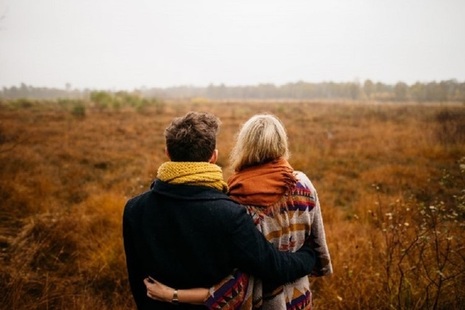 Man and woman standing in a field