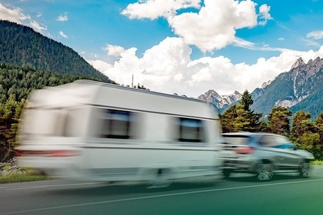 Image of caravan being towed by car.