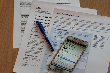 Probate forms, papers and calculator on a table