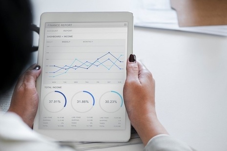 Picture of a woman looking at paper with analysis chart: phot credit by rawpixel