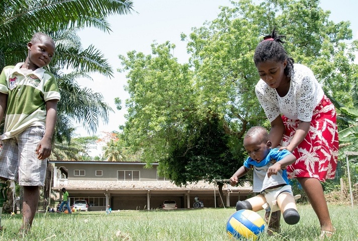 Legs in Africa charity helping a boy with no legs kick a ball