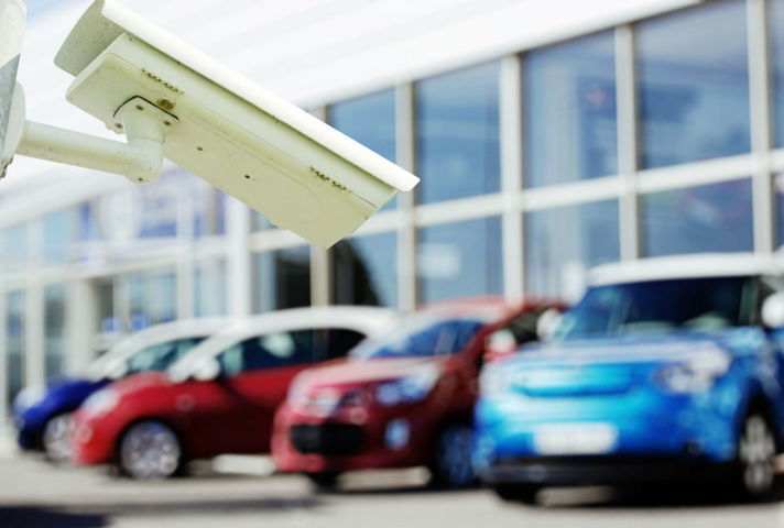 Image of surveillance camera in front of parked cars