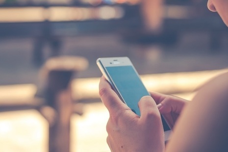 A young person holding a smartphone