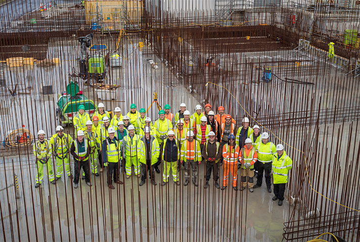 The team and senior management are photographed before the final concrete pour takes place