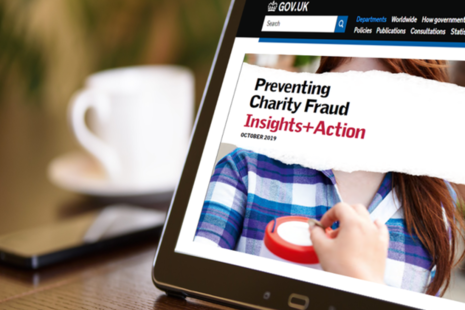 A computer screen showing the front cover of a research report about fraud in UK charities.