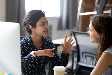 A young entrepreneur getting business support from a female colleague.