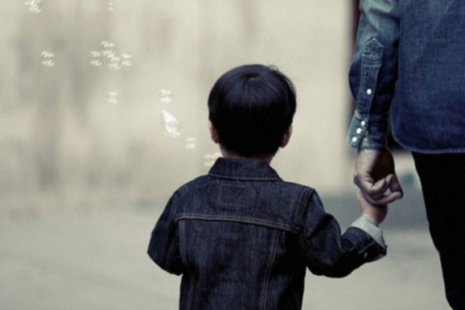 Child holding adult's hand