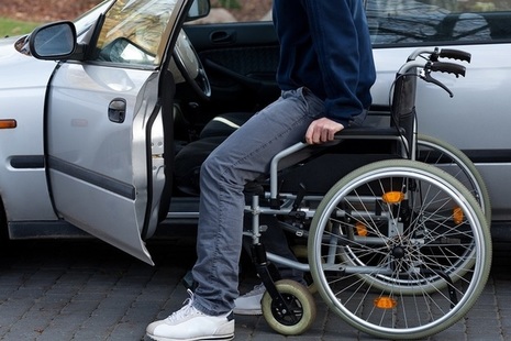 Man with wheelchair getting into car